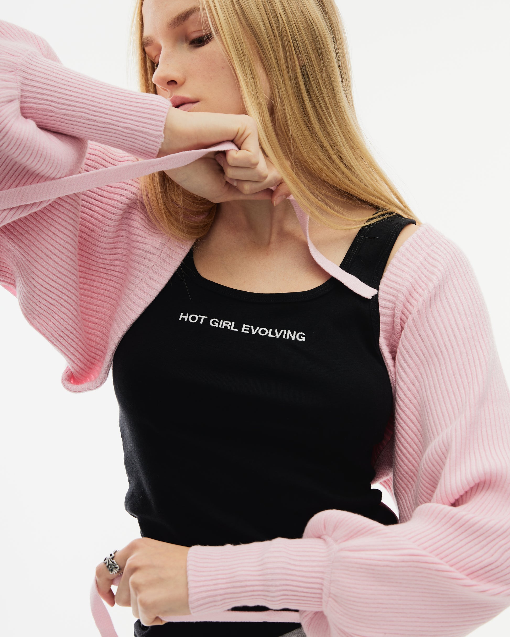 Model wearing black embroidered Hot Girl Evolving Tank Top with pink sweater